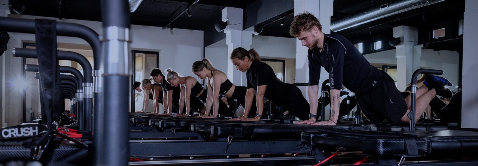 People training on a pilates reformer during a high-intensity class at CRUSH Studios in Haarlem