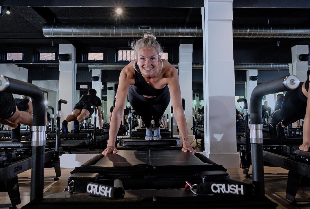 Woman training consistently on a pilates reformer at CRUSH Studios in Haarlem