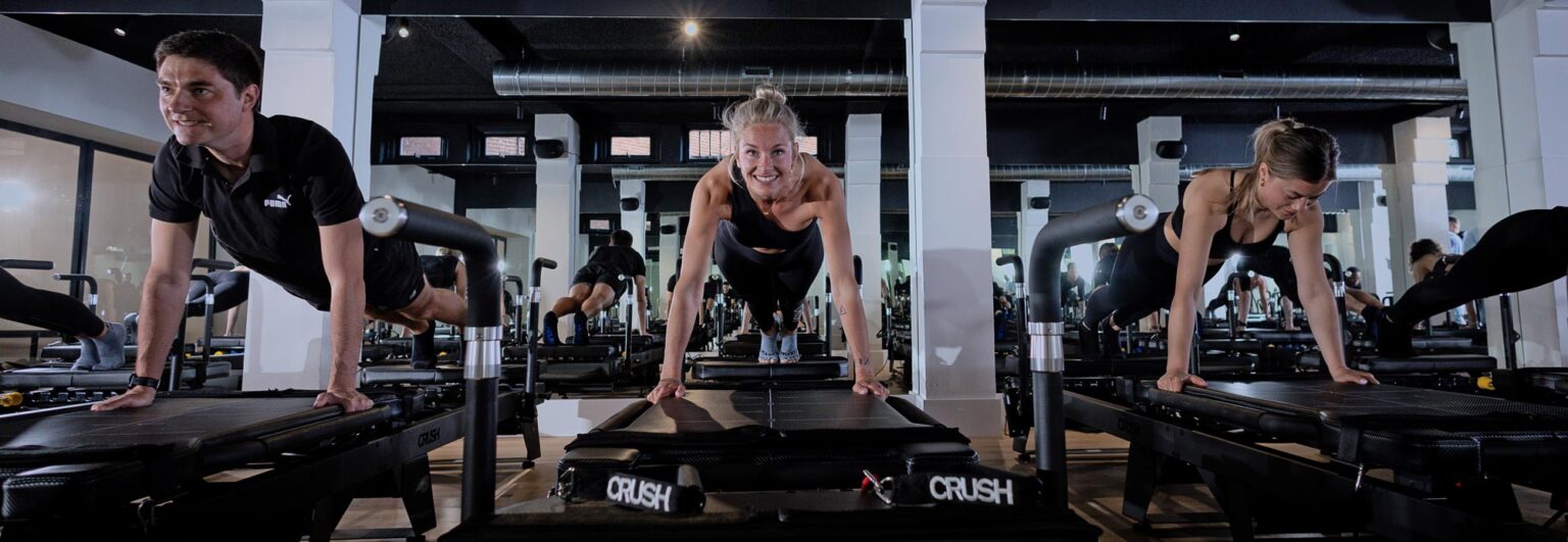 Woman training consistently on a pilates reformer at CRUSH Studios in Haarlem