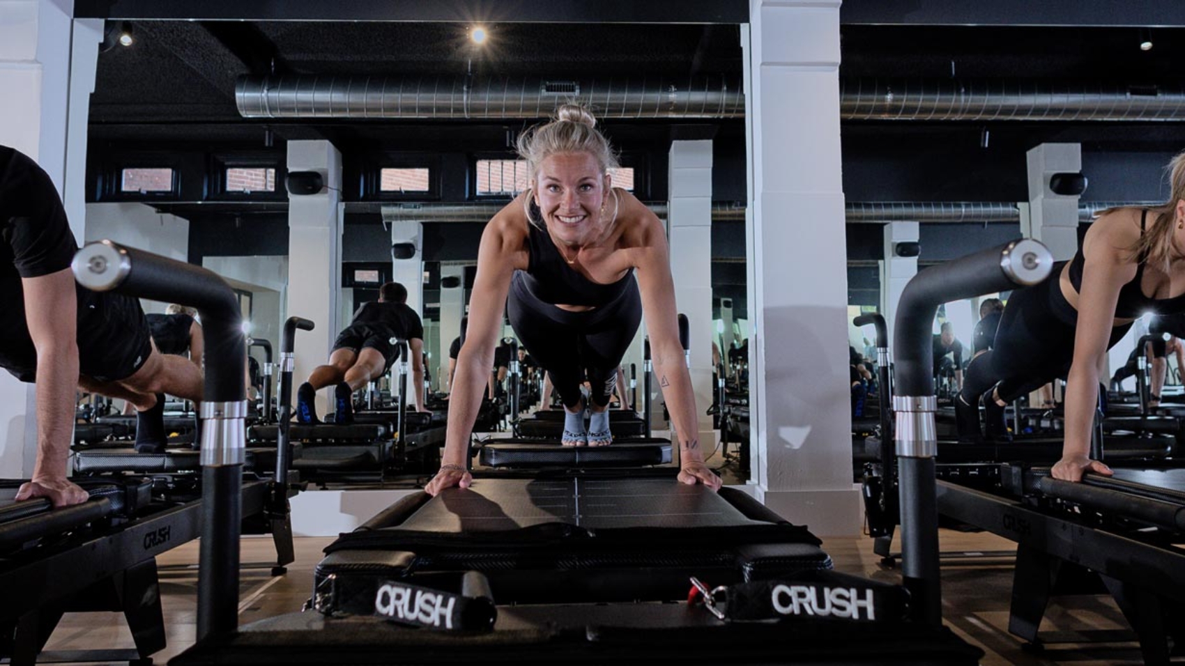 Woman training consistently on a pilates reformer at CRUSH Studios in Haarlem