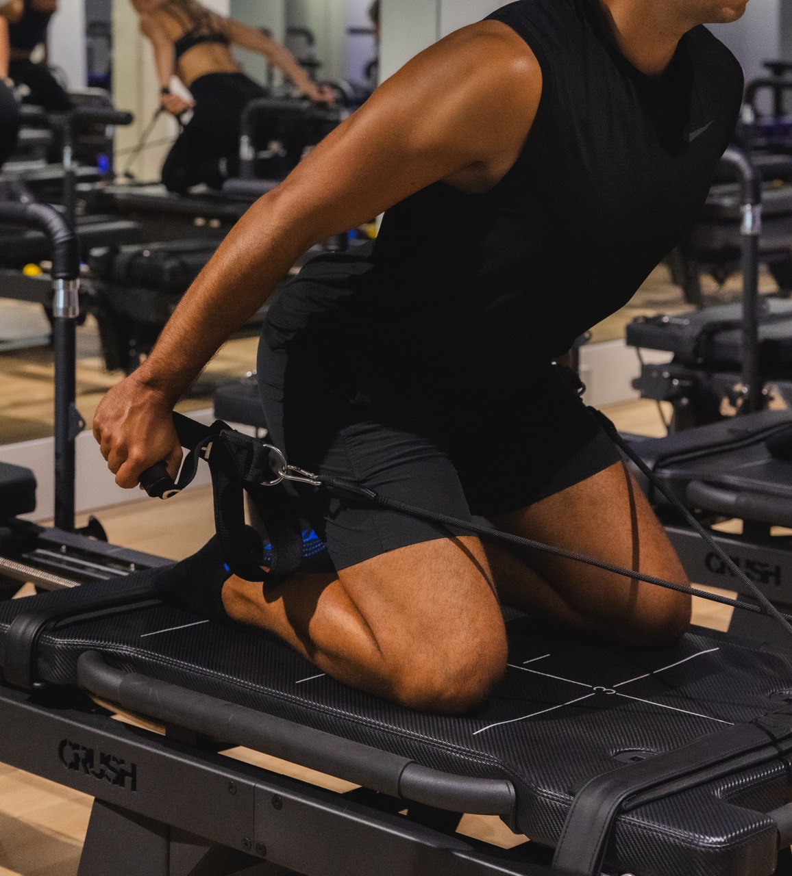 Leg strap exercise on the reformer at CRUSH Studios in Haarlem